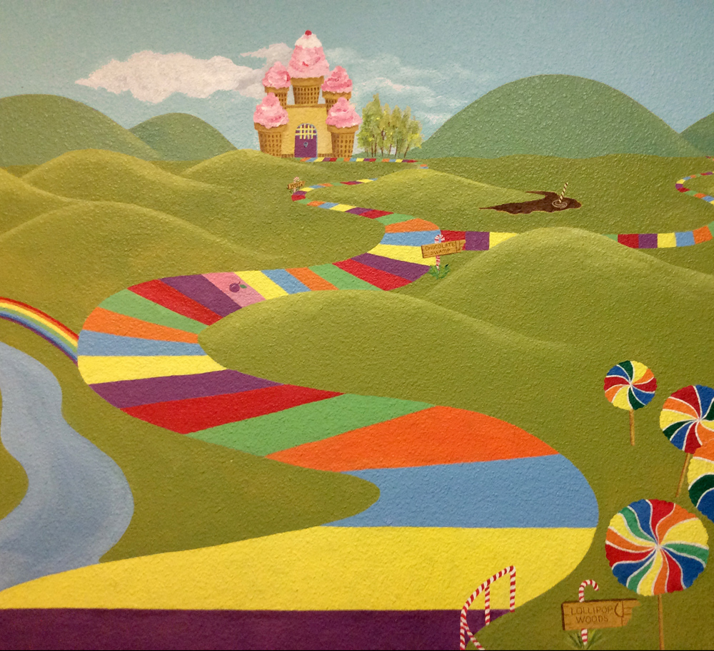 Colorful candy-themed mural with lollipop paths and a candy house inside Sweet Chico Confections