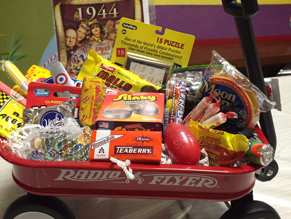 Red Radio Flyer wagon gift basket filled with nostalgic candy, toys, puzzles, and treats at Sweet Chico Confections